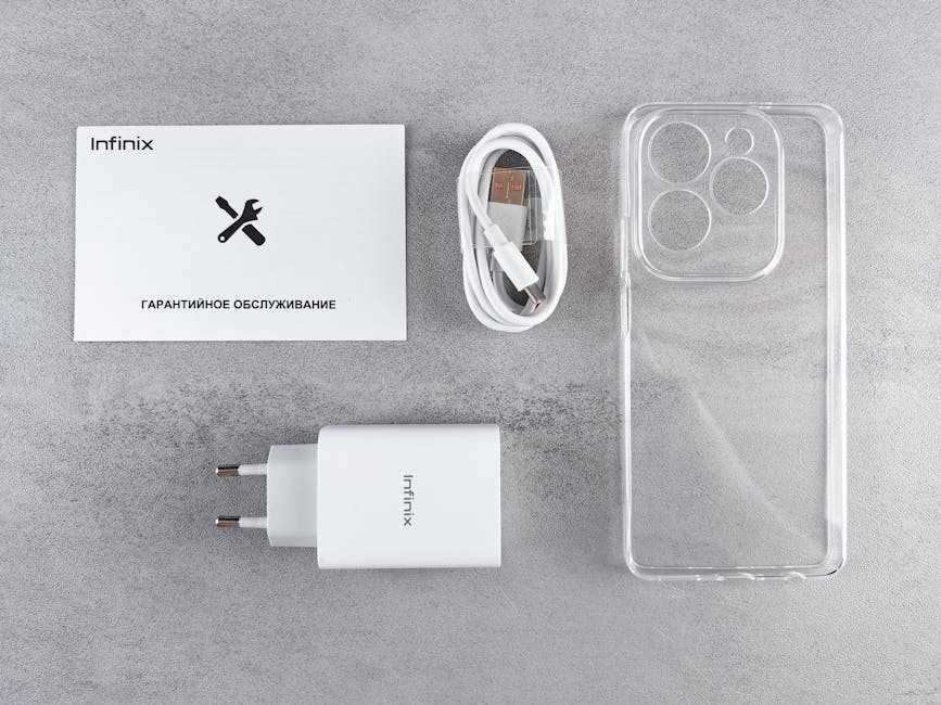 Flat lay of Infinix smartphone accessories with charger, cable, case, and warranty card.
